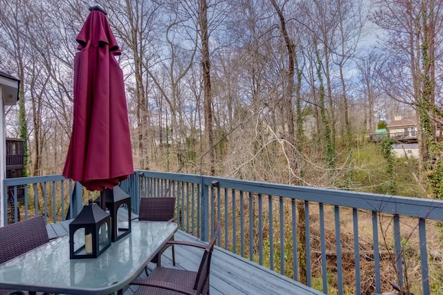 wooden terrace with outdoor dining space