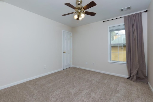 unfurnished room featuring baseboards, visible vents, carpet floors, and ceiling fan