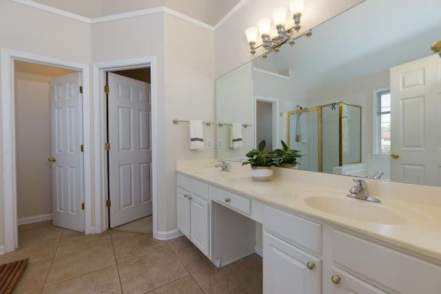 bathroom with tile patterned flooring, double vanity, a stall shower, and a sink