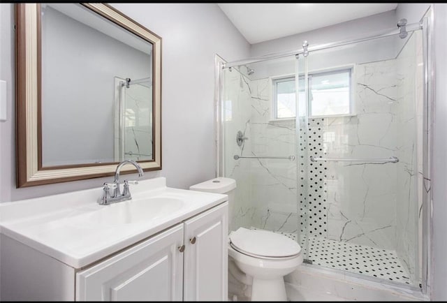 bathroom featuring walk in shower, vanity, and toilet