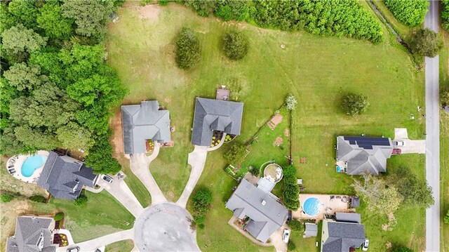 aerial view of property's location with a pool area and nearby suburban area