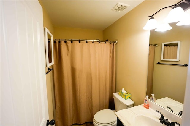 full bathroom with toilet, vanity, and curtained shower