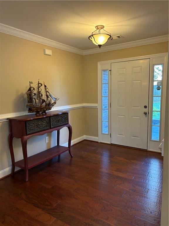 foyer entrance with crown molding, baseboards, and dark wood-type flooring