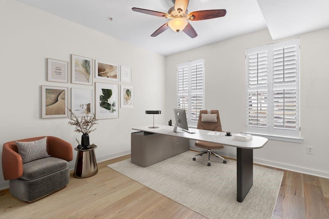 office area featuring a ceiling fan, wood finished floors, and baseboards