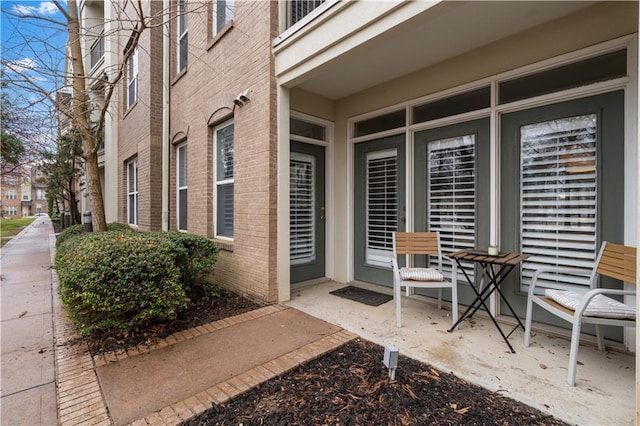 doorway to property featuring brick siding