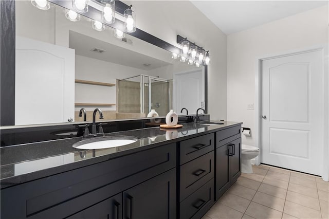 bathroom with a sink, visible vents, a shower stall, and tile patterned floors