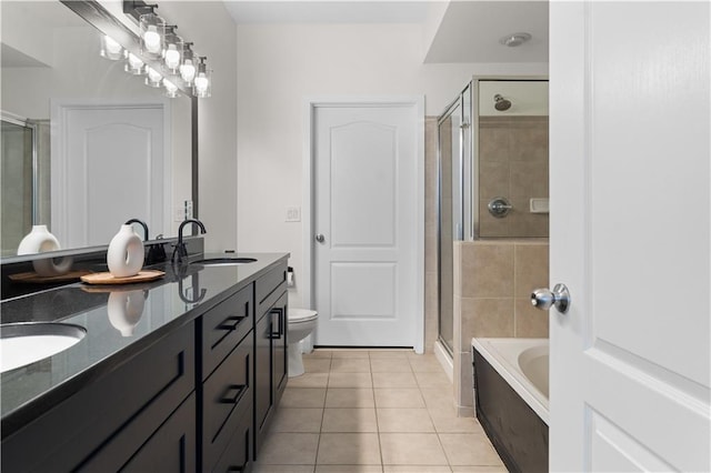 bathroom featuring a sink, a shower stall, and tile patterned flooring