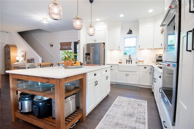 kitchen with tasteful backsplash, high quality fridge, sink, and white cabinetry