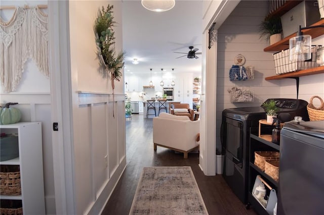 hallway with separate washer and dryer and dark hardwood / wood-style floors