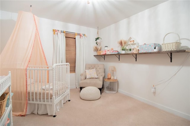 carpeted bedroom with a nursery area