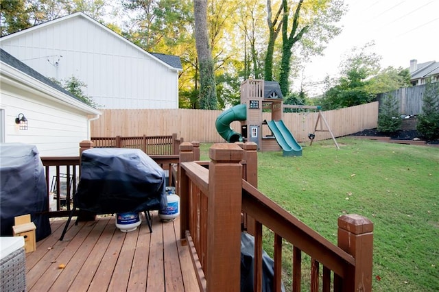 wooden deck featuring a playground, grilling area, and a lawn