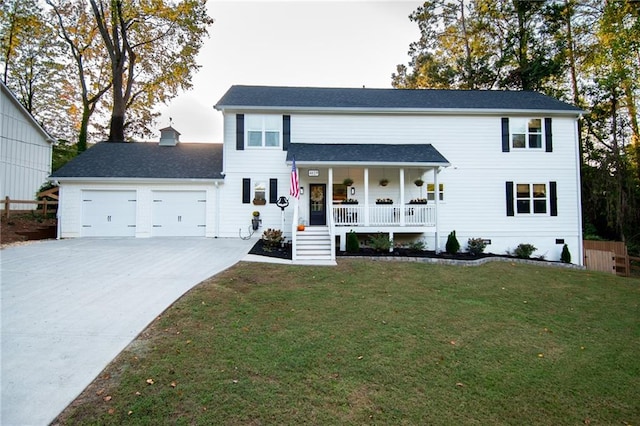 view of front of home with a garage, a front lawn, and covered porch