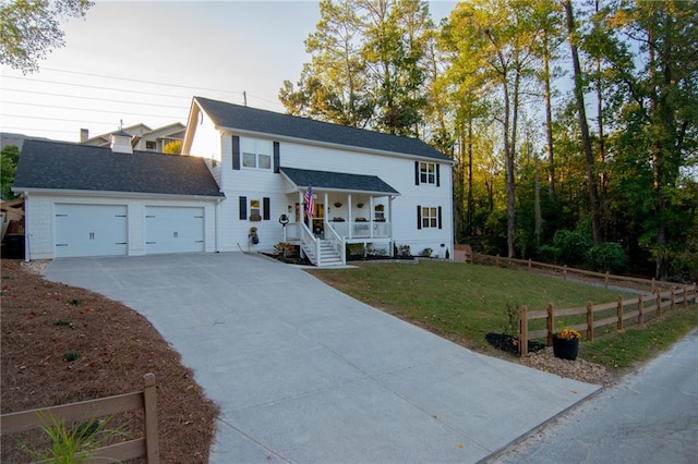 view of front facade featuring a front lawn, covered porch, and a garage