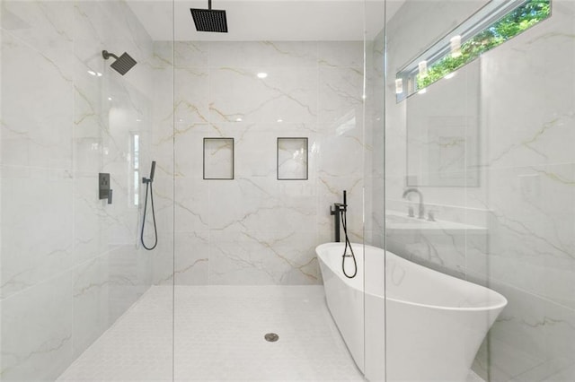 327 Ohm Ave, Avondale Estates, GA 30002 - bathroom featuring tile walls, a soaking tub, and a marble finish shower