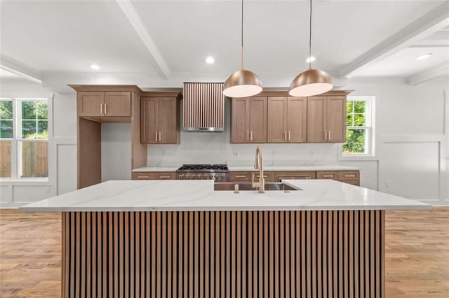 327 Ohm Ave, Avondale Estates, GA 30002 - kitchen featuring light wood-type flooring, beam ceiling, hanging light fixtures, healthy amount of natural light, and ventilation hood