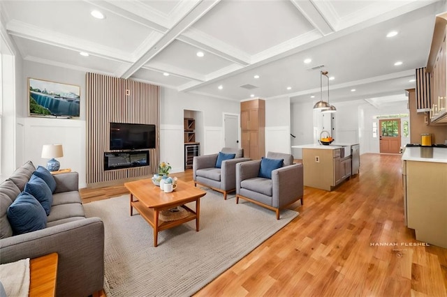 327 Ohm Ave, Avondale Estates, GA 30002 - living area with coffered ceiling, light wood-style flooring, beamed ceiling, recessed lighting, and ornamental molding