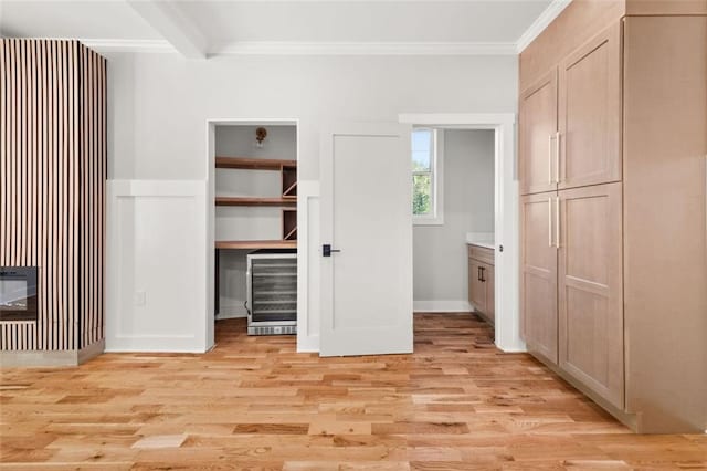 327 Ohm Ave, Avondale Estates, GA 30002 - unfurnished bedroom featuring wine cooler, crown molding, light wood-style flooring, baseboards, and a spacious closet