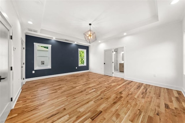 327 Ohm Ave, Avondale Estates, GA 30002 - empty room featuring a tray ceiling, light wood finished floors, recessed lighting, a chandelier, and baseboards