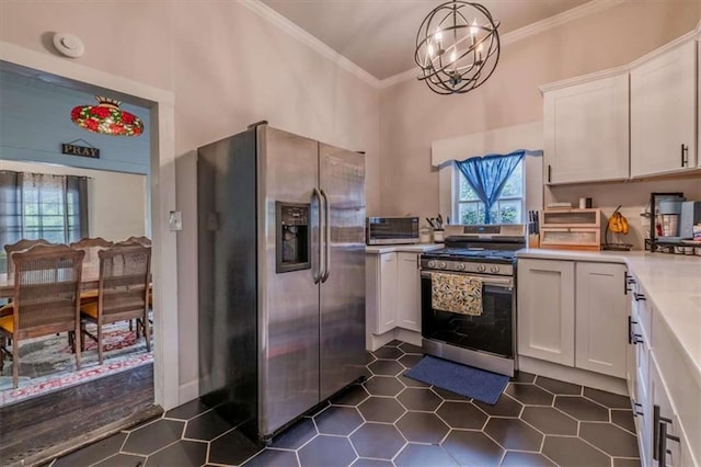 229 Slate St, Rockmart, GA 30153 - kitchen featuring appliances with stainless steel finishes, healthy amount of natural light, white cabinetry, crown molding, and light countertops