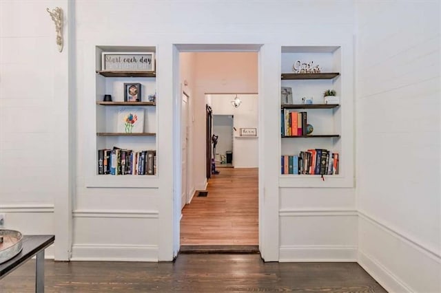 229 Slate St, Rockmart, GA 30153 - hall with built in shelves, dark wood-type flooring, and baseboards