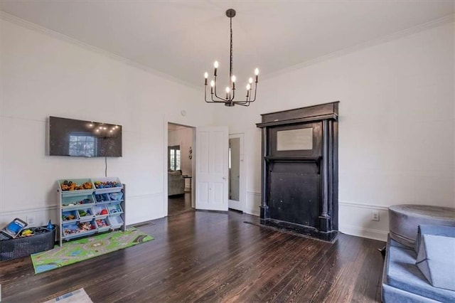 229 Slate St, Rockmart, GA 30153 - unfurnished living room with a chandelier, wood finished floors, crown molding, baseboards, and a fireplace