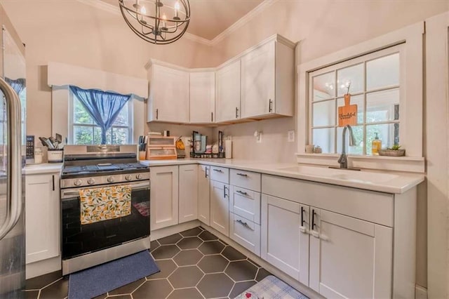 229 Slate St, Rockmart, GA 30153 - kitchen featuring stainless steel appliances, ornamental molding, a sink, light countertops, and a chandelier