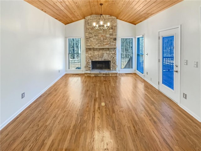 unfurnished living room featuring vaulted ceiling, wood finished floors, wood ceiling, and plenty of natural light