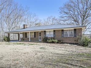 6267 Mount Pisgah Rd, Ellijay, GA 30540 - ranch-style home featuring brick siding, covered porch, driveway, and a chimney