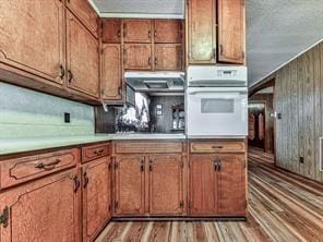 6267 Mount Pisgah Rd, Ellijay, GA 30540 - kitchen with light countertops, brown cabinetry, and oven