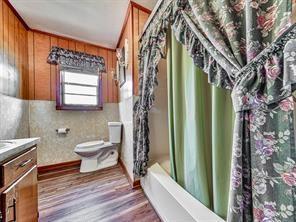 6267 Mount Pisgah Rd, Ellijay, GA 30540 - bathroom featuring vanity, toilet, wood finished floors, and wood walls