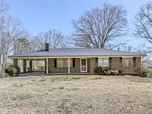6267 Mount Pisgah Rd, Ellijay, GA 30540 - view of front of house featuring an attached carport, metal roof, and a chimney