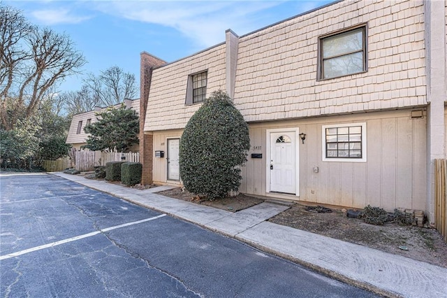 multi unit property with fence and mansard roof