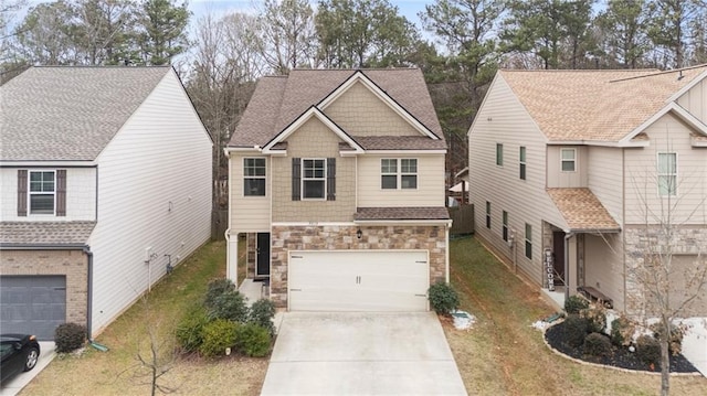 view of front of house featuring stone siding, a shingled roof, concrete driveway, and a front yard