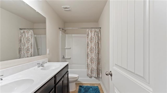 full bath with visible vents, a sink, toilet, and double vanity