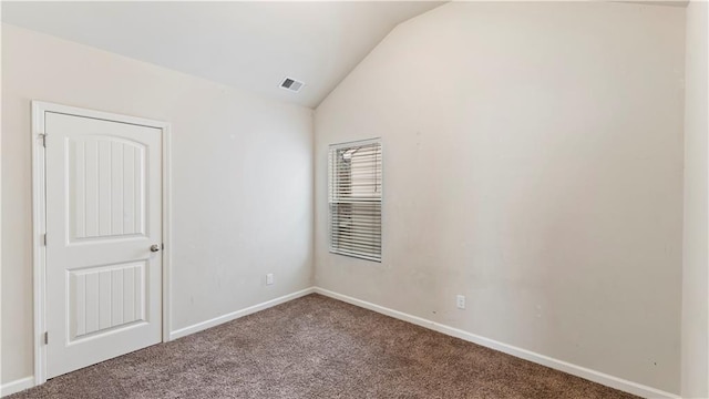 carpeted empty room with lofted ceiling, visible vents, and baseboards