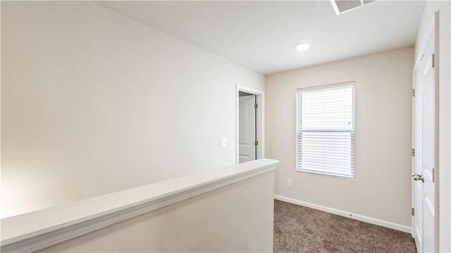 corridor with carpet floors and baseboards