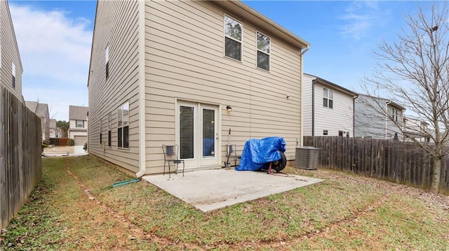 rear view of property with a patio, a lawn, and fence