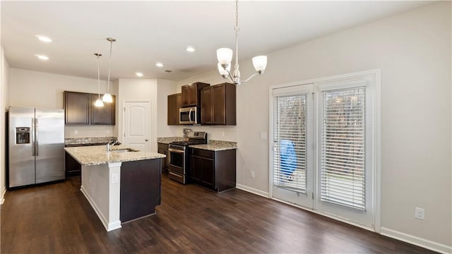 kitchen featuring stainless steel appliances, dark wood-type flooring, a sink, and dark brown cabinetry