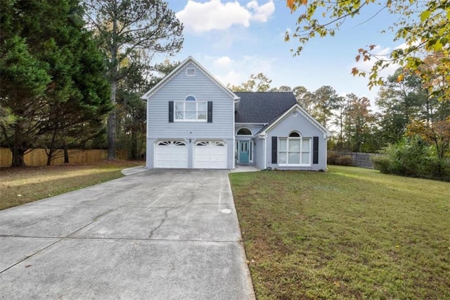 view of front of house featuring driveway, a front lawn, an attached garage, and fence