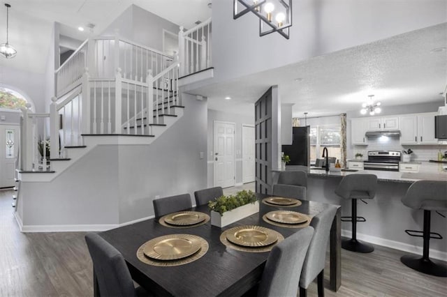 dining area featuring plenty of natural light, stairway, and wood finished floors