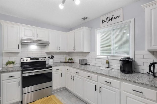 kitchen featuring white cabinetry, under cabinet range hood, visible vents, and stainless steel electric stove