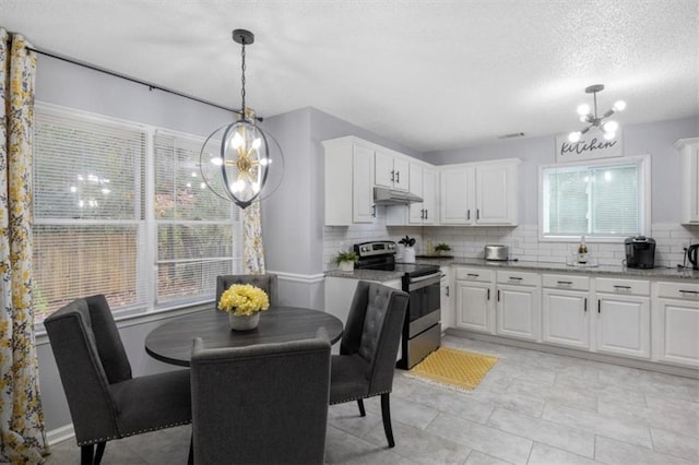 kitchen featuring decorative light fixtures, backsplash, white cabinetry, and stainless steel range with electric cooktop