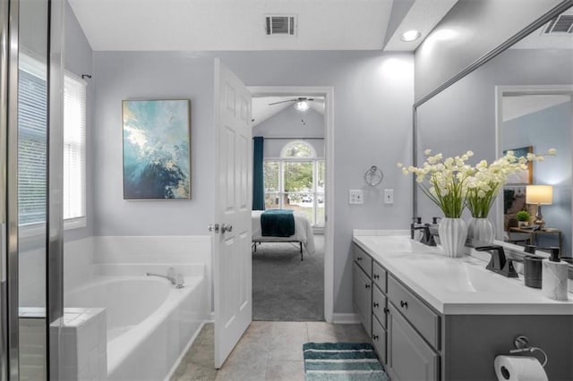 bathroom featuring double vanity, a garden tub, visible vents, and a sink