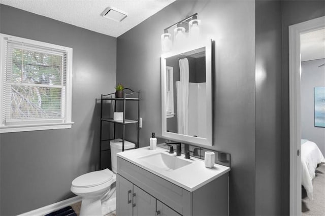 bathroom with visible vents, vanity, toilet, and baseboards