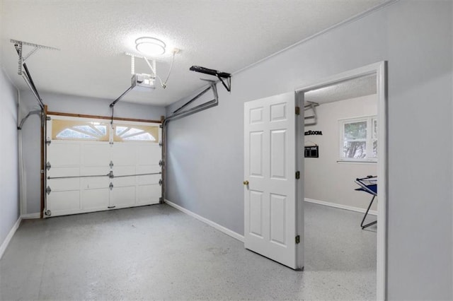 garage with a garage door opener and baseboards