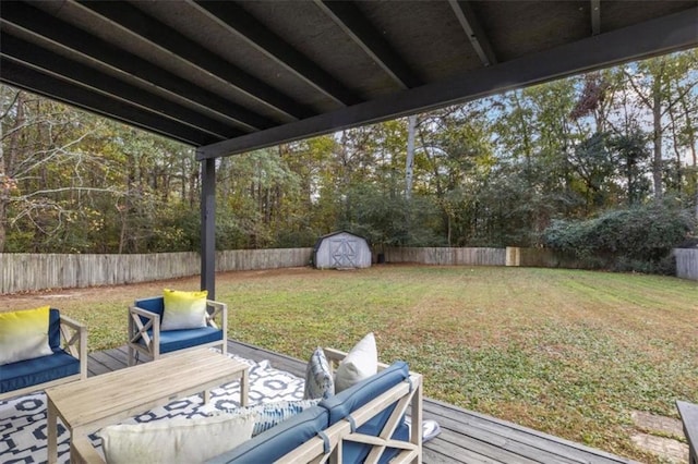 view of yard featuring a storage shed, a fenced backyard, an outdoor living space, and an outbuilding