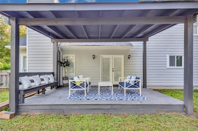 wooden deck featuring french doors, fence, and an outdoor living space