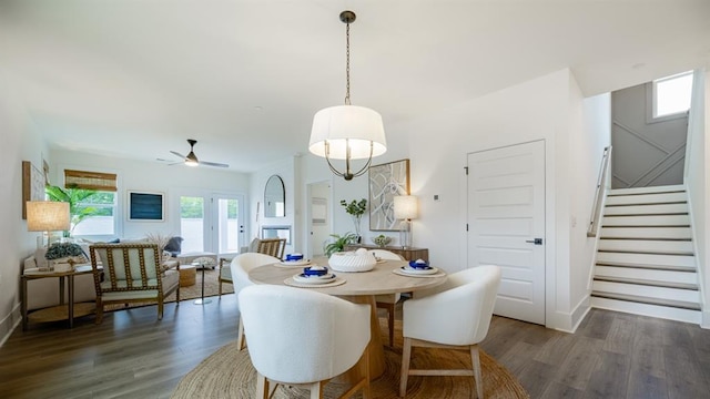 dining area featuring stairway, wood finished floors, ceiling fan, and baseboards