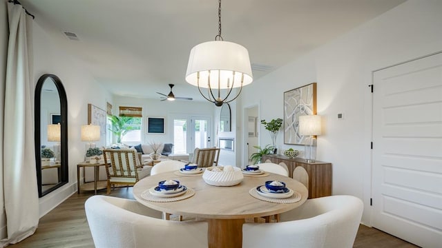 dining area with wood finished floors and ceiling fan