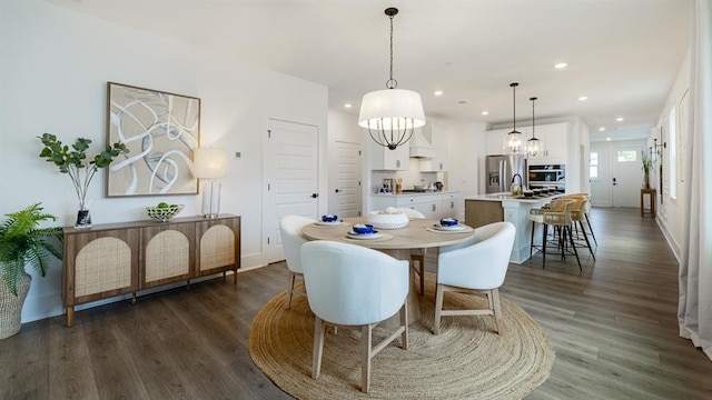 dining room featuring recessed lighting, dark wood-style floors, baseboards, and a chandelier